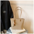 Vista detallada del bolso tote de cuero beige con borla de cuentas y costuras de gran precisión - Caqui