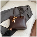 Detailed view of woven texture on dark brown tote bag with beaded tassel charm - Coffee With Pendant