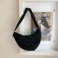 Close-up of a black nylon crescent crossbody bag with adjustable strap and metal zipper - Black