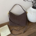 Close-up of vintage brown suede shoulder bag with gold hardware on rustic wooden table - No Pendant / Brown