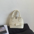 Chic beige shell handbag in textured PU leather with bow detail and silver eyelets - Milk Yellow