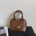 Brown shell handbag with vintage pleated texture and decorative bow detail - Caramel color
