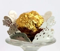 Macro shot of silver laser-cut angel paper candy holder for chocolate ball gifts - Reflective Silver