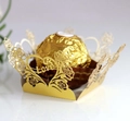 Close-up of laser-cut gold chocolate wrapper with rose motifs and Love engraving - Reflective Gold