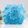 Detail of light blue laser-cut candy box featuring elegant floral patterns and a ribbon bow - Sky Blue