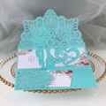 Macro detail of laser-cut 3D wedding invitation featuring Mr & Mrs pop-up silhouettes - Tiffany Blue