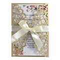 Macro detail of laser-cut gold wedding invitation with navy floral insert and ribbon - Champagne Gold