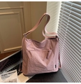 Light pink nylon tote bag with woven zipper detail and adjustable strap for daily commute - Pink