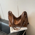 Fashionable dark brown PU leather large tote bag with metallic logo on black sofa - Brown No Pendant