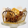 Macro detail of laser-cut golden birdcage candy box with intricate floral patterns - Reflective Gold