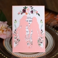 Laser-cut pink wedding invitation showing two female silhouettes and floral inner card - Pink
