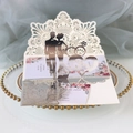 Macro detail of laser-cut wedding invitation featuring rings and floral pattern - Reflective Silver