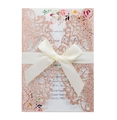 Close-up of rose gold glitter laser-cut wedding invitation with white silk ribbon bow - Glitter Champagne Gold
