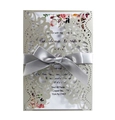 Detail of laser cut wedding invitation with hollow floral patterns and silver ribbon bow - Silver Grey