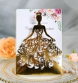 Close-up of laser-cut golden wedding invitation with intricate princess gown patterns - Reflective Gold
