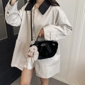 Schwarze Kunstpelz-Tragetasche mit Schnalle und Hasenanhänger am beigen Trenchcoat - Schwarz Mit Anhänger