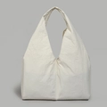 Detail view of large white tote bag featuring pleated nylon fabric and deep V-shaped top - White
