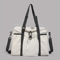 Detail view of large nylon travel tote with drawstring pocket and black buckle fastener - White
