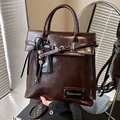 Glossy dark brown faux leather backpack with metallic buckle and decorative charms - Coffee (With Pendant)