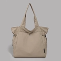 Detail of khaki nylon tote bag showing drawstrings and secure black snap closure - Khaki