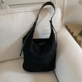 Black suede hobo bag with adjustable silver buckle strap on minimalist fabric sofa - Black without Pendant