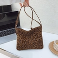 Chic leopard print shoulder bag with adjustable brown leather strap in office setting - Leopard Print No Charm