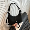 Minimalist black crescent shoulder bag in soft suede-like texture with silver buckle - Black
