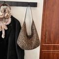 Retro leopard print tote bag with brown slim straps hanging in a stylish setting - Green