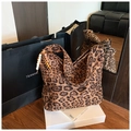 Detail of leopard print tote bag with decorative wooden beads on a display stand - Large Pattern With Charm / Brown Leopard