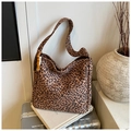 Detail view of leopard print canvas tote bag with wooden bead charm and wide shoulder strap - Small Pattern With Charm / Brown Leopard