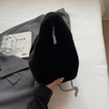 Chic black plush bucket bag with silver chain strap on a minimalist studio set - Black