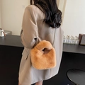 Brown fuzzy faux fur bucket bag with chain strap shown on model in casual style - Brown