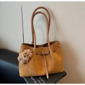 Detail of vintage brown suede tote bag with metal buckle and plush puppy charm - Khaki With Pendant