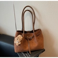 Detail of vintage caramel suede tote bag with leather straps and cute plush bear charm - Brown with Pendant