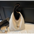 Detail view of canvas hobo tote with colorful zebra embroidery and brown leather trim - One Size / Off White