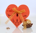 Detailed laser-cut heart favor box with elegant floral patterns and a golden satin bow - Orange Red