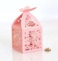 Close-up of pink laser-cut favor box with rose patterns and 3D butterfly closure - Pink
