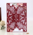 Detail of burgundy laser cut wedding invitation with intricate mandala floral patterns - Dark Red