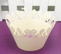 Close-up of laser-cut hollow crown pattern cupcake wrappers in cream white cardstock - Ivory