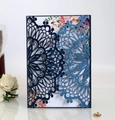 Detail of laser-cut navy blue wedding invitation with floral insert and gold rings - Dark Blue