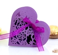 Macro view of purple laser-cut heart candy box with rose patterns and satin ribbon - Dark Purple