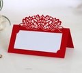 Red laser-cut wedding place card with elegant scrollwork and white insert card - Pearlescent Red