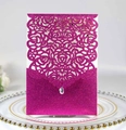 Macro detail of laser-cut glitter rose invitation with hollow design and teardrop rhinestone - Glitter Fuchsia