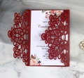 Elegant laser-cut burgundy wedding invitation set with floral inner card on marble background - Dark Red