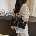 Fashion tote bag with black and grey leopard print and gold tennis racquet charm - Black