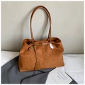 Detail of vintage brown suede tote bag with textured surface and smooth leather straps - Brown