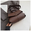 Detail of dark brown leather handbag featuring contrast stitching and gold twist-lock buckle - Brown