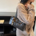 Sac à bandoulière rétro en similicuir noir avec boucle dorée et breloque en perles sur modèle - Avec Pendentif / Noir