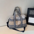 Close-up of stylish gray and beige waterproof tote bag with striped ribbon handles - Gray