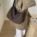 Minimalist dark brown suede crossbody bag with vintage wooden bead tassels worn by model - Coffee with Pendant